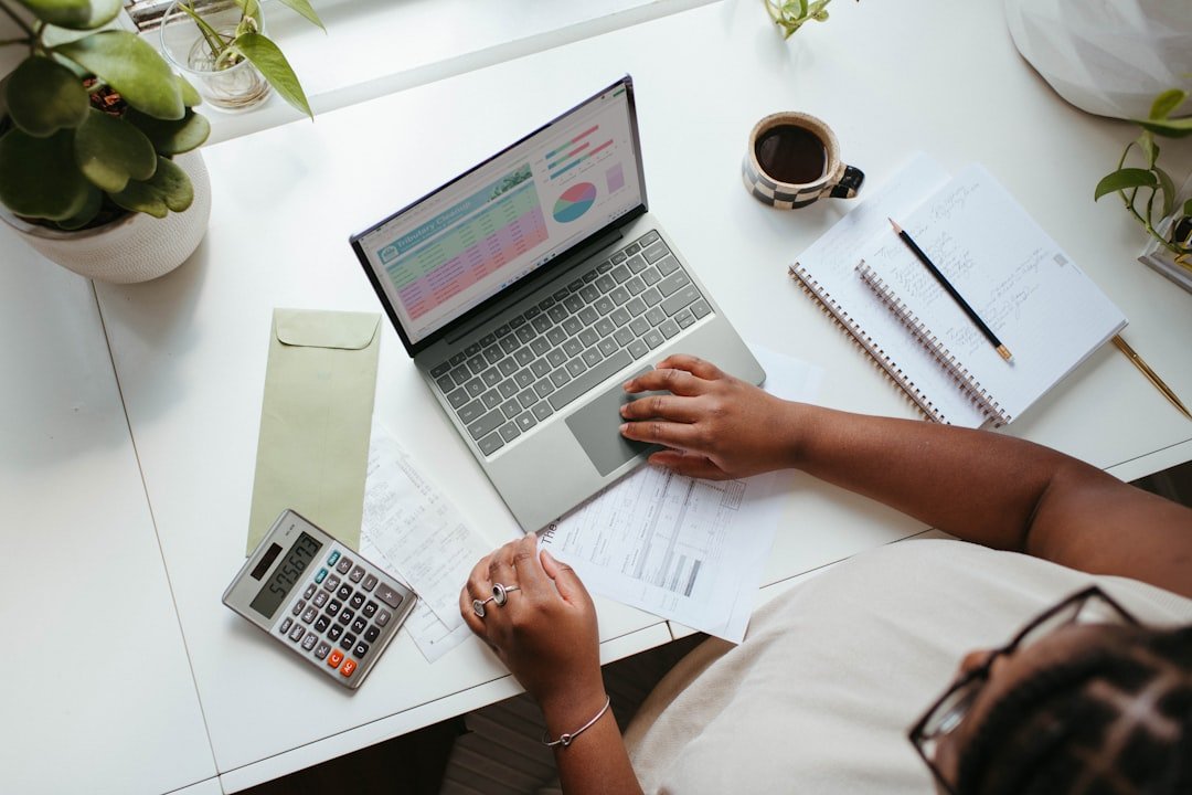 Small-business owner using a laptop to plan cash flow and finances