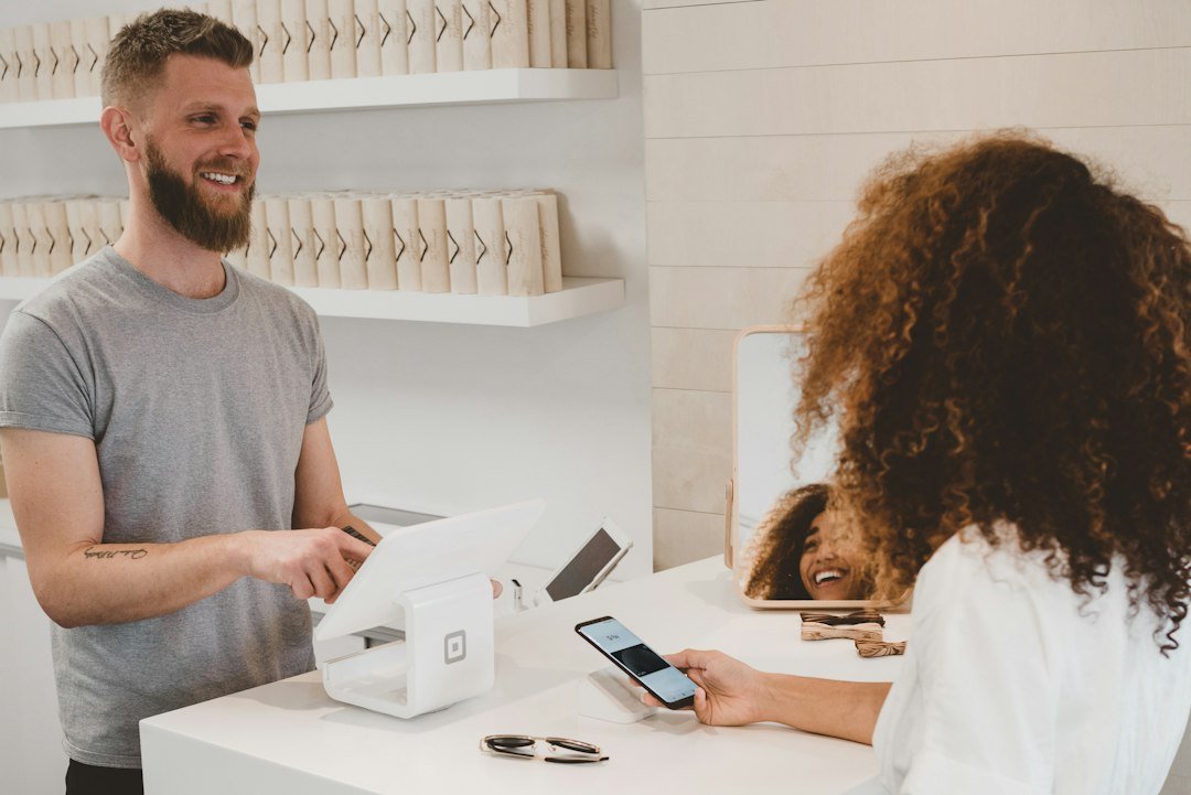 Small-business owner helping a customer as part of a customer retention strategy