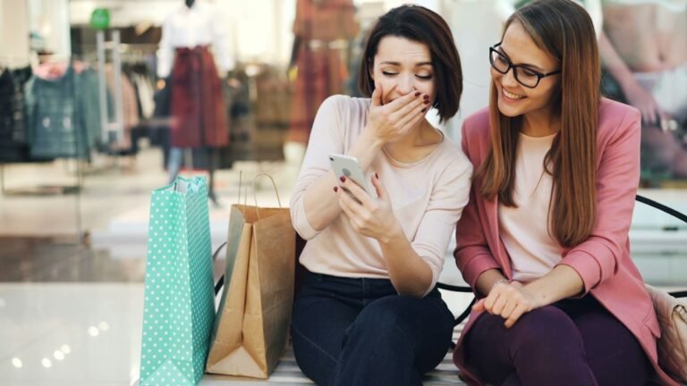 Customers using a smartphone while shopping, representing local business search