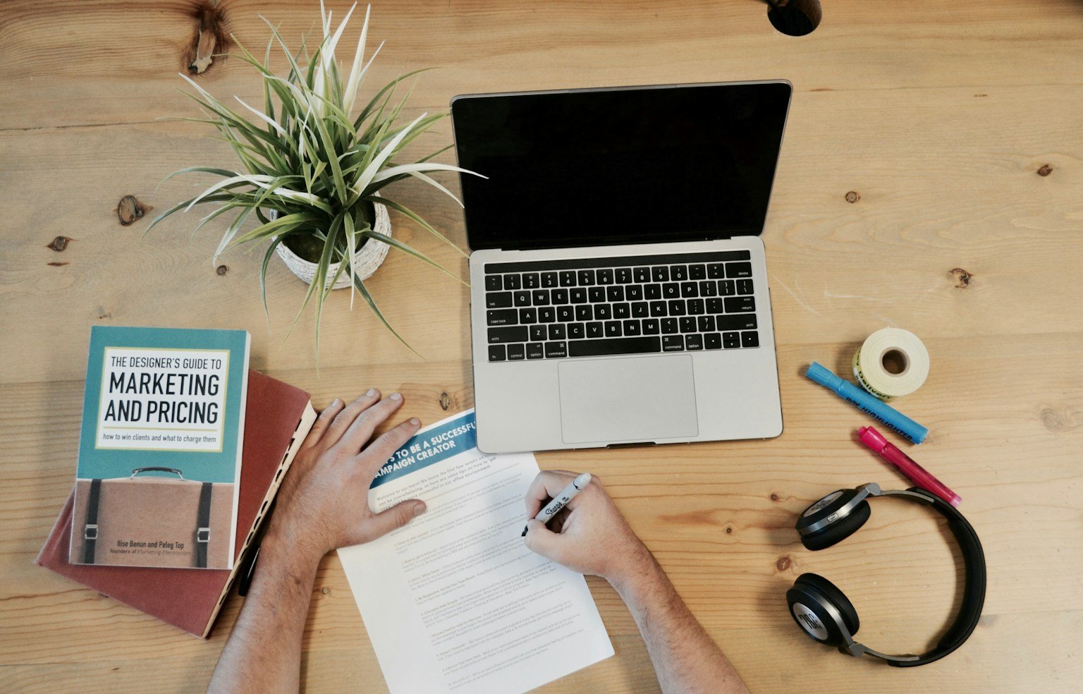 Digital marketing content review workspace with laptop and notes