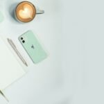 Marketing workspace with laptop and phone for planning Pinterest content